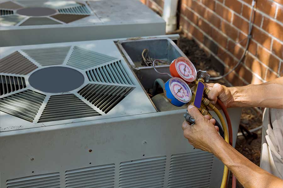 HVAC technician performing routine AC maintenance on an outdoor unit in Huntington, WV