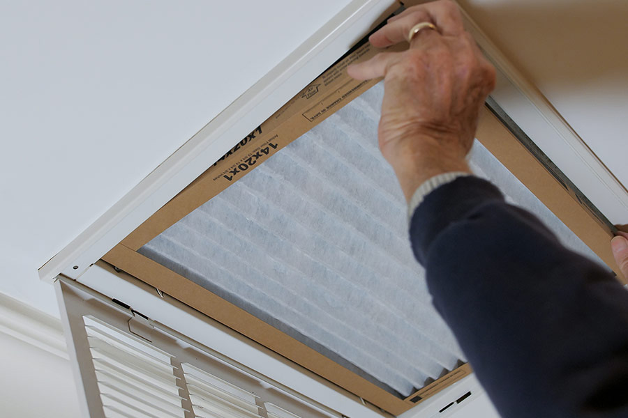 Person changing AC filter